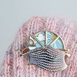 Unique spinning enamel pin for knitters. 'Day and Night' spinner knitting pin, for knitters can pass the whole day knitting. A fun knitting accessory for any project bag!