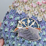 Unique spinning enamel pin for knitters. 'Moon Phase' spinner knitting pin, for knitters can pass the whole night knitting. A fun knitting accessory for any project bag!