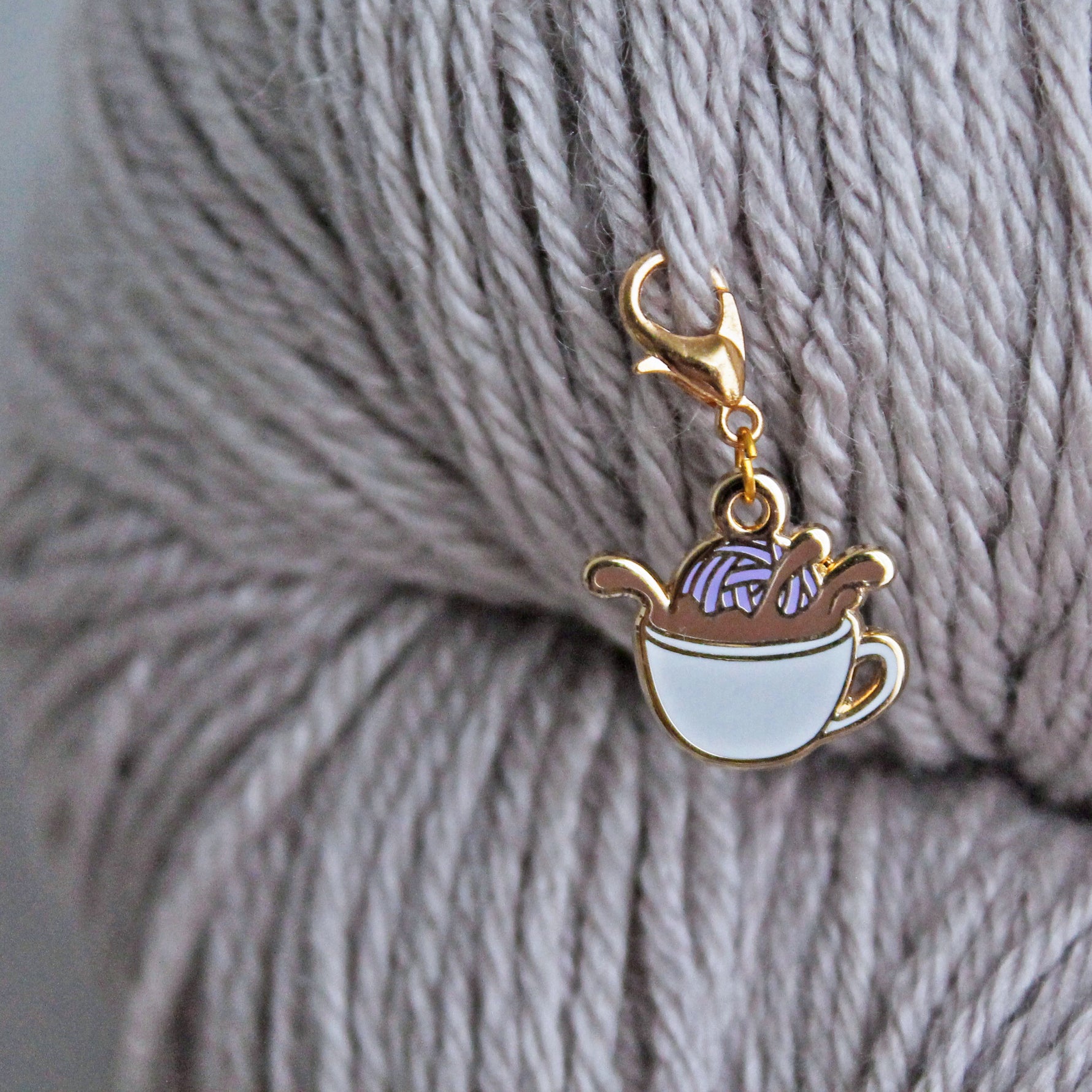 The perfect progress keeper for coffee lovers! This coffee cup charm with a yarn ball dunking into coffee is attached to a lobster clasp and can also double as a stitch marker.