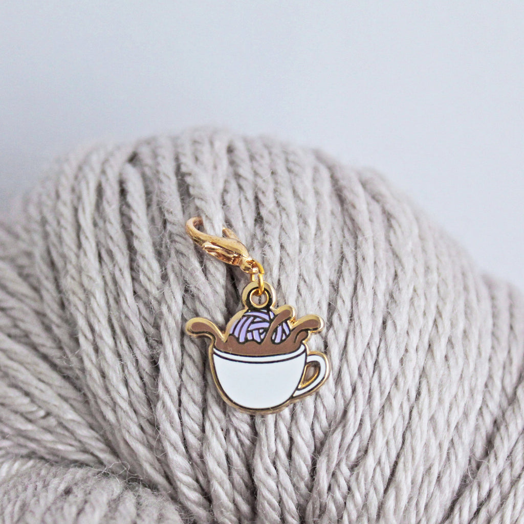 The perfect progress keeper for coffee lovers! This coffee cup charm with a yarn ball dunking into coffee is attached to a lobster clasp and can also double as a stitch marker.