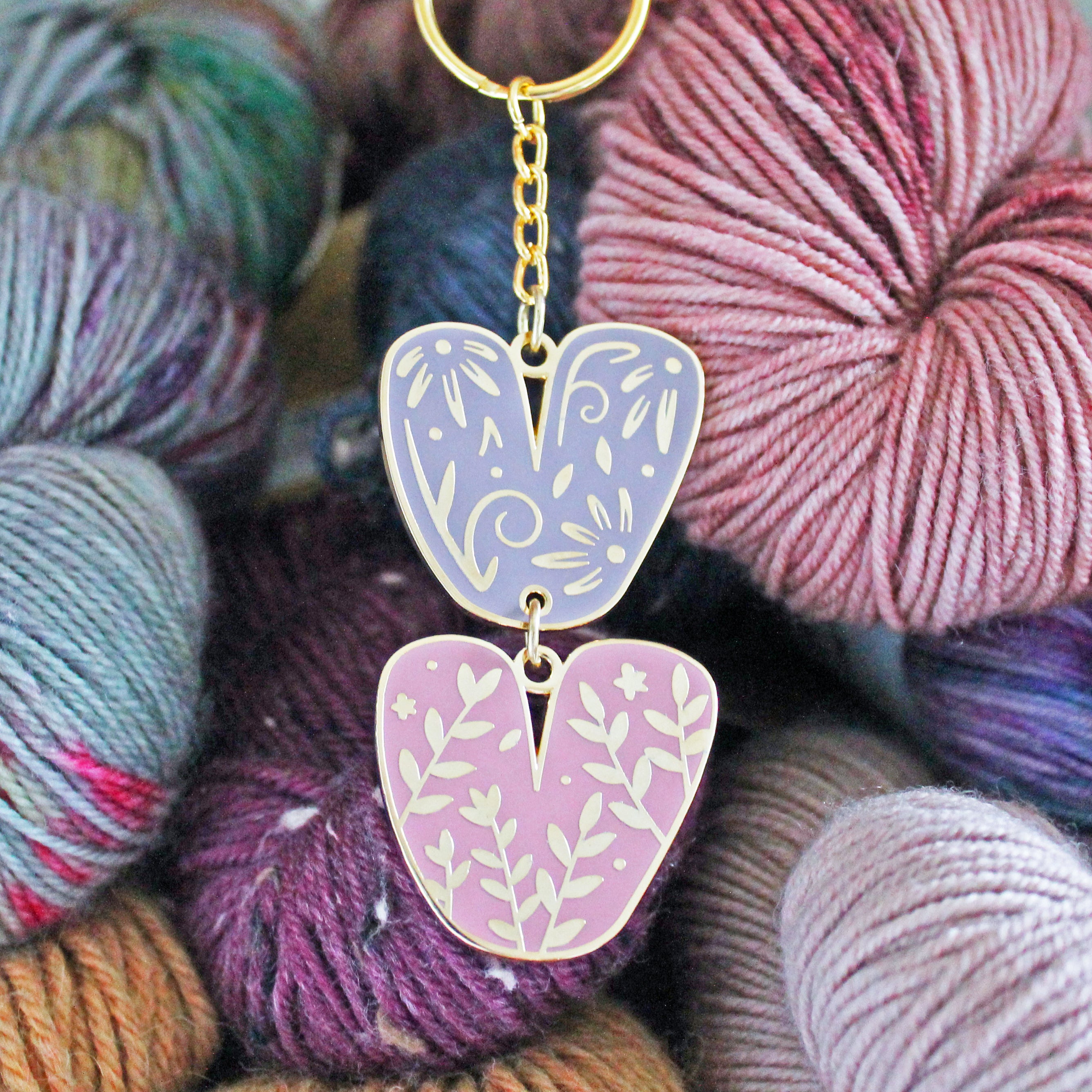 Keychain of floral chunky knit stitches. Fun knitting enamel keychain for fiber enthusiasts.