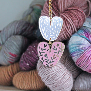 Keychain of floral chunky knit stitches. Fun knitting enamel keychain for fiber enthusiasts.