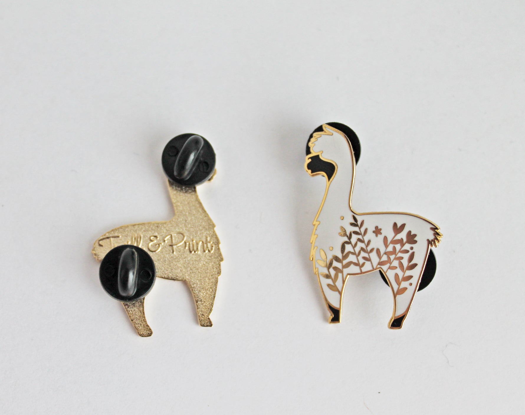 Cute alpaca enamel pin with a little floral whimsy. A beautiful pin made for animal lovers, fiber enthusiasts, knitters and crocheters.