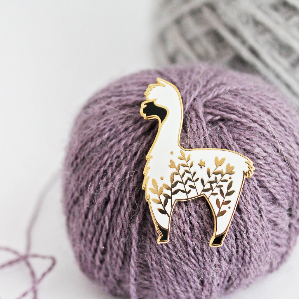 Cute alpaca enamel pin with a little floral whimsy. A beautiful pin made for animal lovers, fiber enthusiasts, knitters and crocheters.