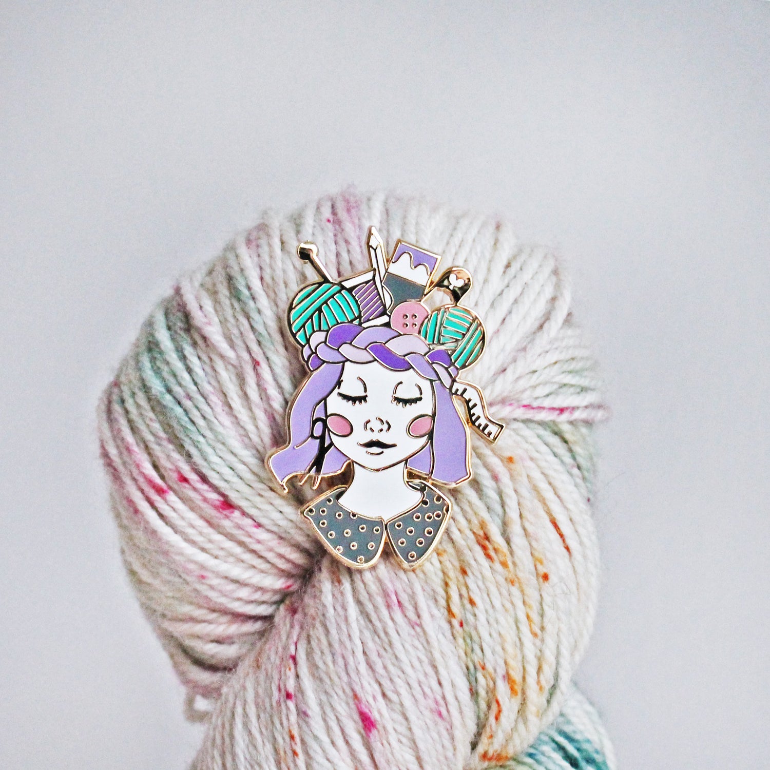 Unique pin for crafters, makers, knitters and crocheters. This creative enamel pin features a girl with a crown of craft supplies, available in multiple skin tones.