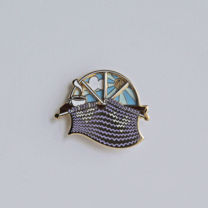 Unique spinning enamel pin for knitters. 'Day and Night' spinner knitting pin, for knitters can pass the whole day knitting. A fun knitting accessory for any project bag!