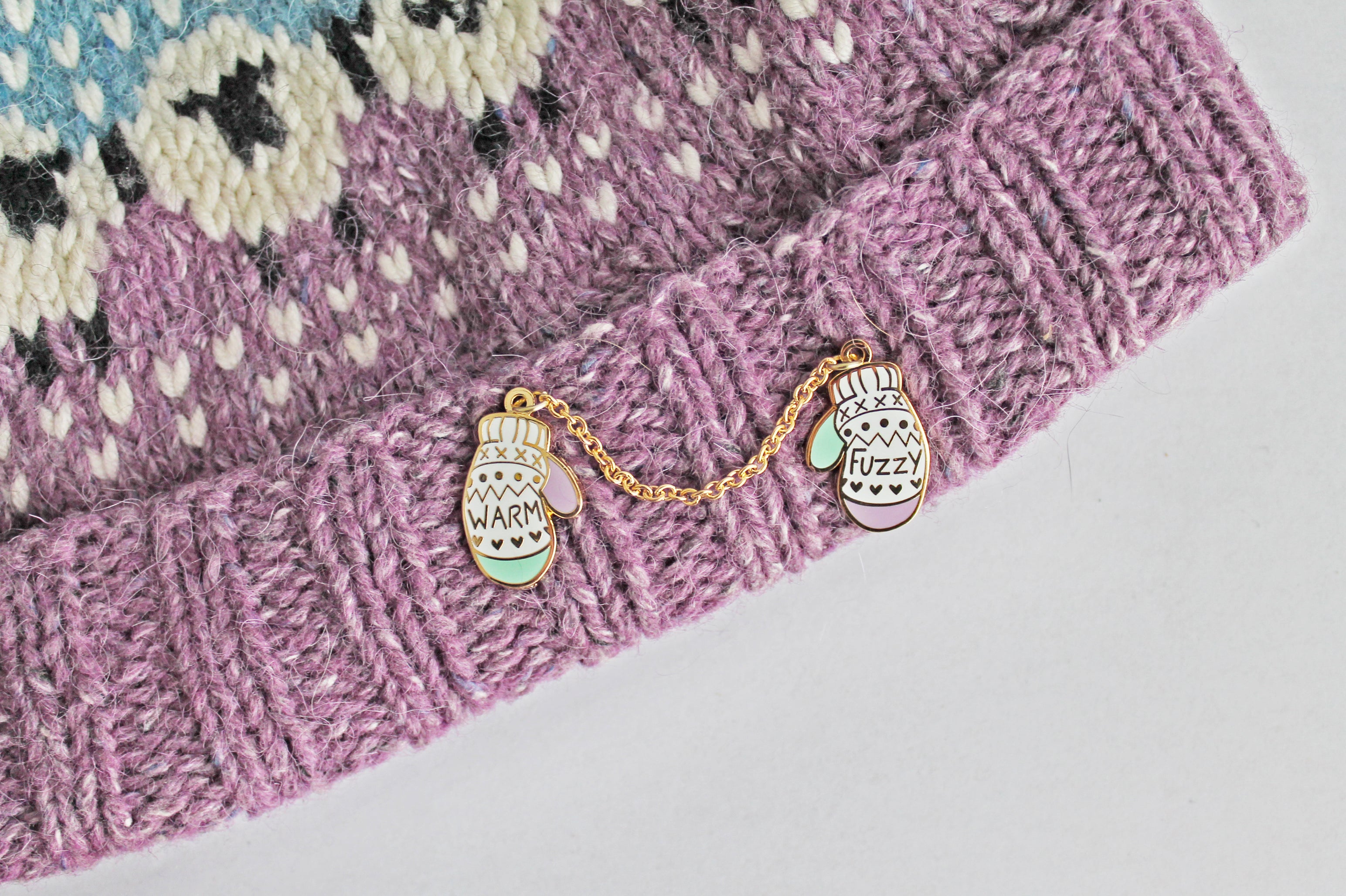 'Warm & Fuzzy' Mittens pin perfect for knitters and winter lovers. Unique enamel pin design, of two mittens attached by a chain.