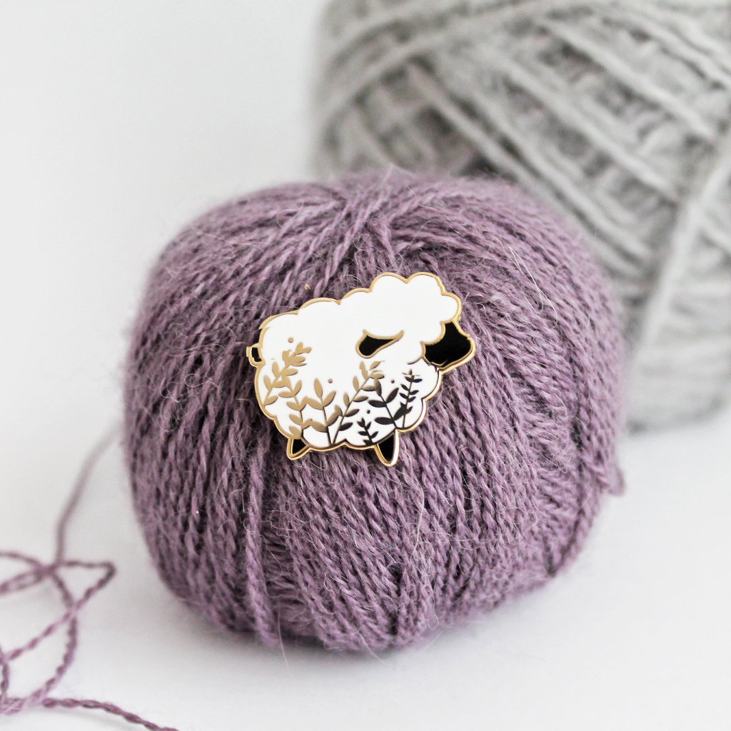 Cute sheep enamel pin with a little floral whimsy. A beautiful pin made for animal lovers, fiber enthusiasts, knitters and crocheters.